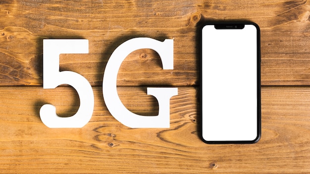 Free photo symbols 5g and smartphone on desk