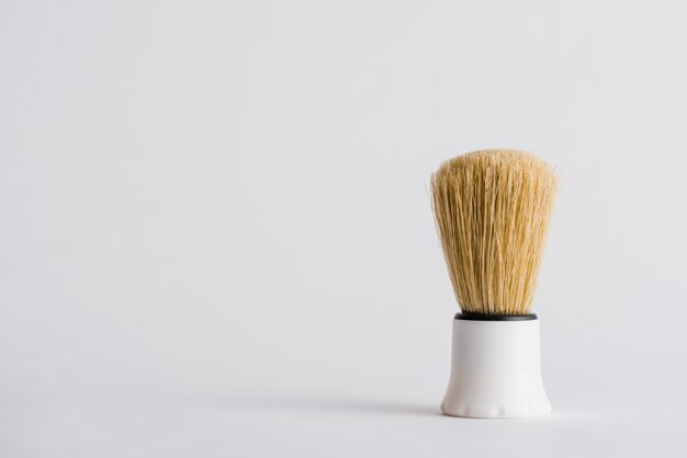 Synthetic shaving brush on grey background