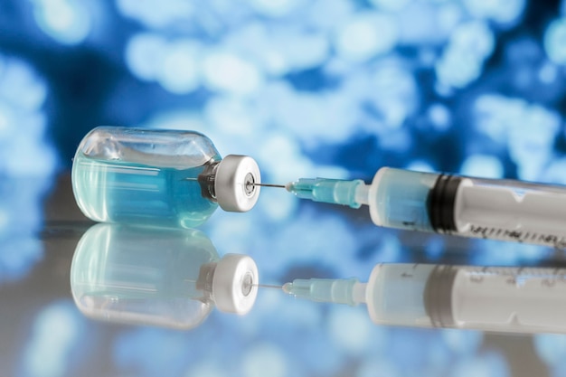 Syringe and vaccine bottle on the table