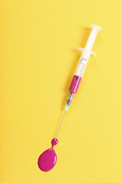 Syringe with pink liquid