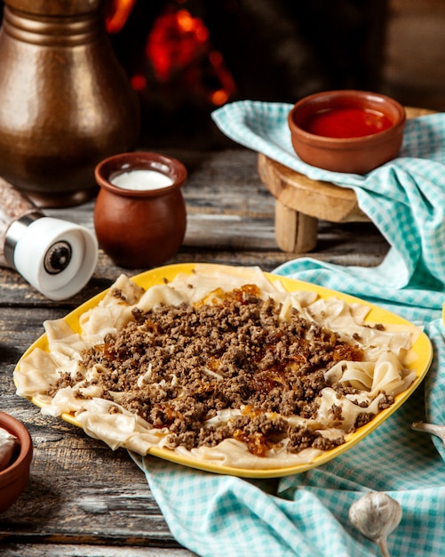 Syuzma khikal  with minced meat  plain youghurt  melted butter  side view