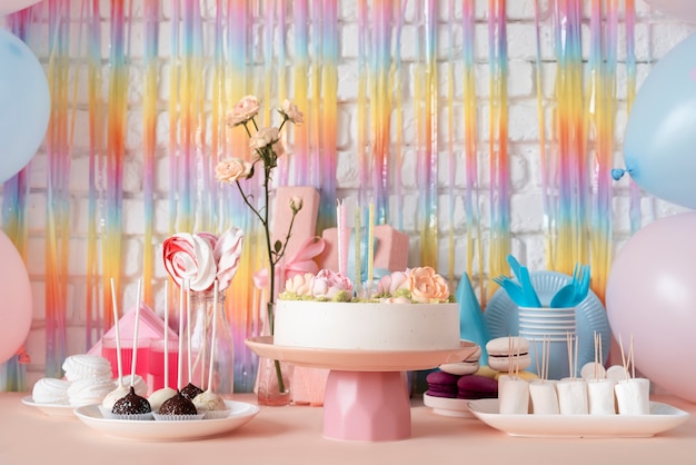 Free photo table arrangement for birthday event with cake and sweets