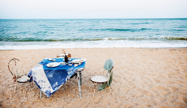 Free photo table chairs meal sea shore holiday sky concept