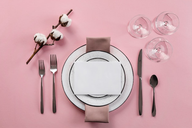 Free photo table etiquette with pink background flat lay