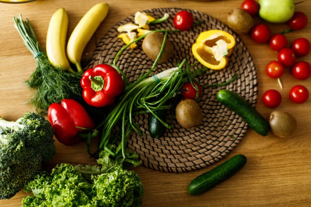 Table flatlay with fresh fruits and vegetables, peppers, onion, cucubmers, tomatos, healthy vibes