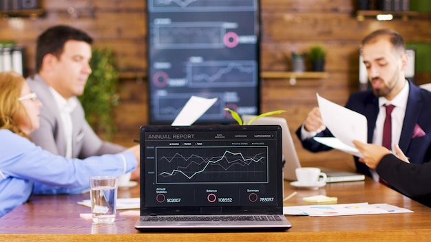 Free Photo on the table laptop showing charts in the conference room. business people having an important discussion.