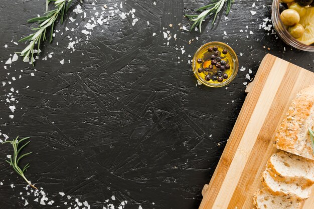 Table with cutting board and bread with oil 