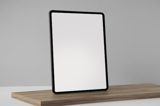 Tablet minimal display on wooden board