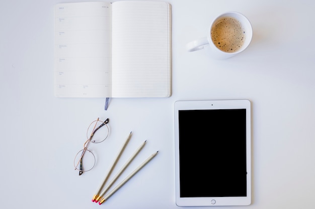 Tablet, organizer. coffee and pencils