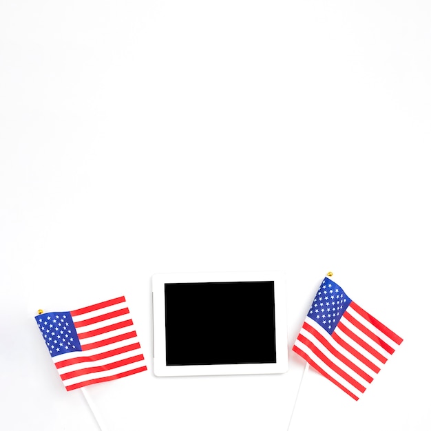 Tablet placed between American flags