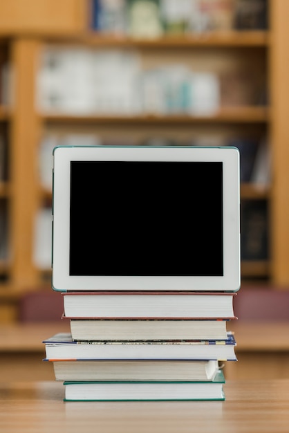 Free Photo tablet on stack of books