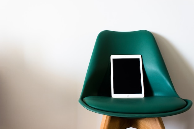 Tablet with blank screen on a chair