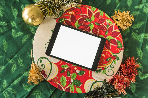 Tablet with Christmas tree branches 