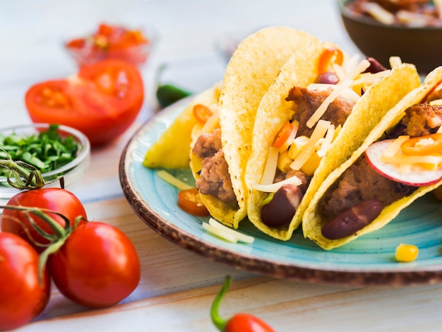 Free photo taco on plate near tomatoes