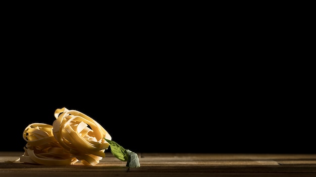 Tagliatelle with basil on desk