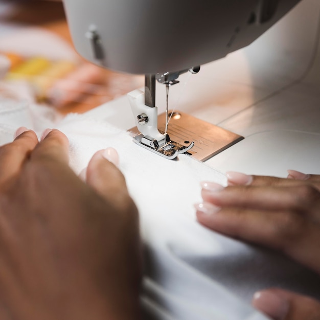 Free Photo tailor using a sewing machine close-up