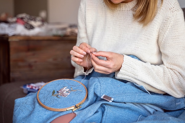 Tailor woman using tools for sewing fabrics