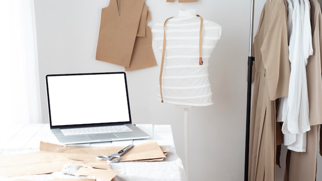 Tailoring studio with dress form and laptop