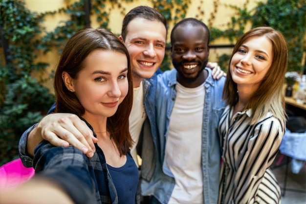 Taking selfie photo with best friends on the warm spring day at the cosy restaurant