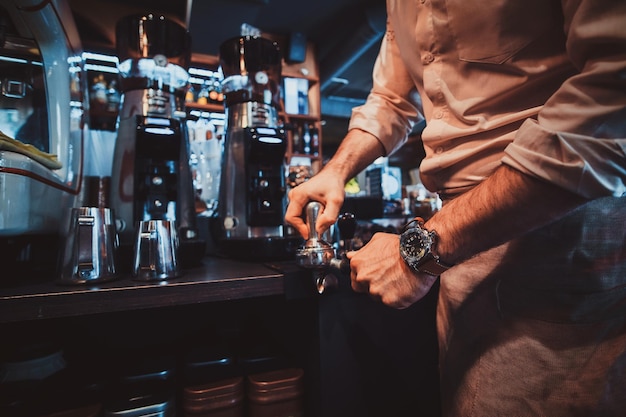 Free Photo talanted barista is prepairing coffee for clients at posh restaurant using coffee machine.