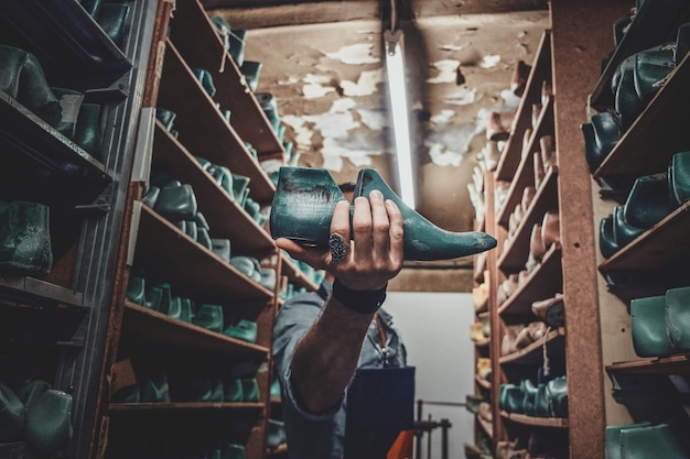 Free Photo talented cobbler finally found right form of shoe for his new project at storage.