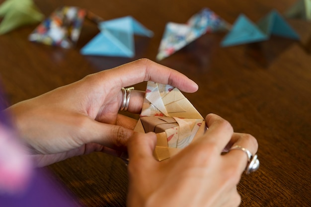 Free Photo talented woman making origami with japanese paper