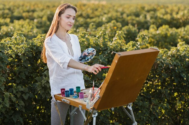 Talented young woman painting