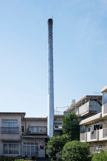 Tall chimney with old houses