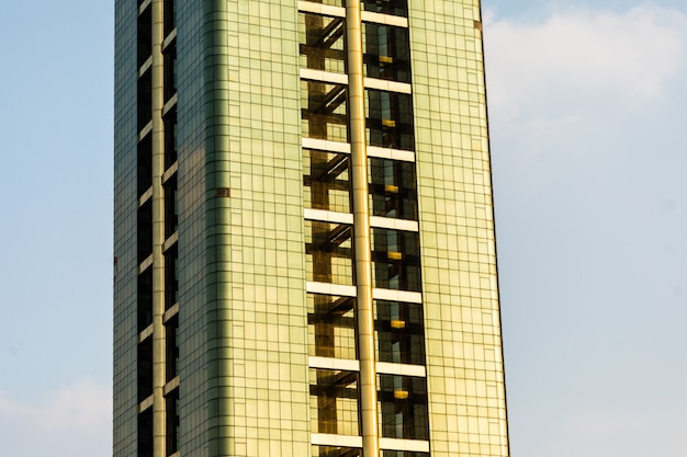 Free photo tall and colorful skycrapers with beautiful blue sky in background.