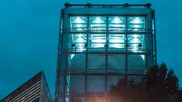 Free photo tall concrete building with blue lights