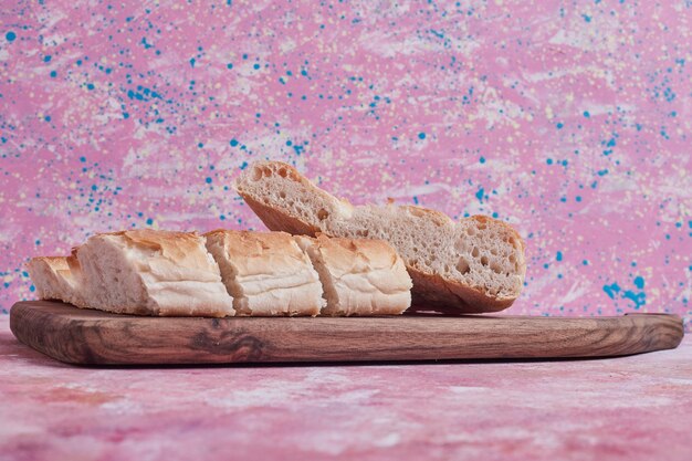 Tandir bread slices on a wooden board.