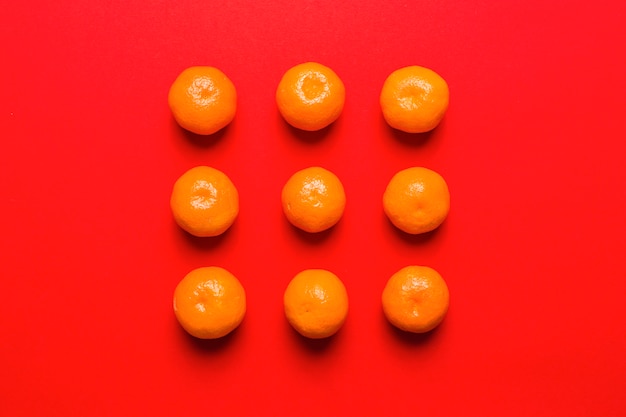 Free photo tangerines composition on red