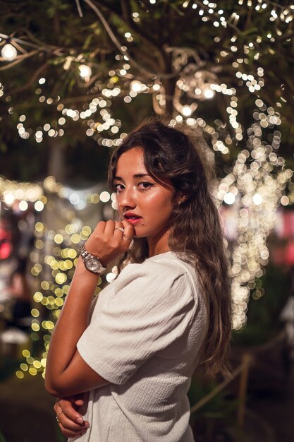 Tanned Caucasian female with fierce posing at an amusement park