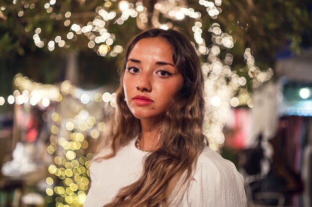 Tanned Caucasian female with fierce posing at an amusement park