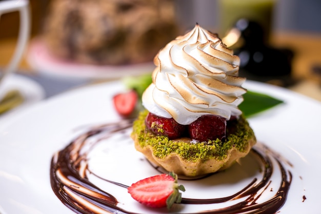 Free photo tartlets with pistachios strawberry cream chocolate side view