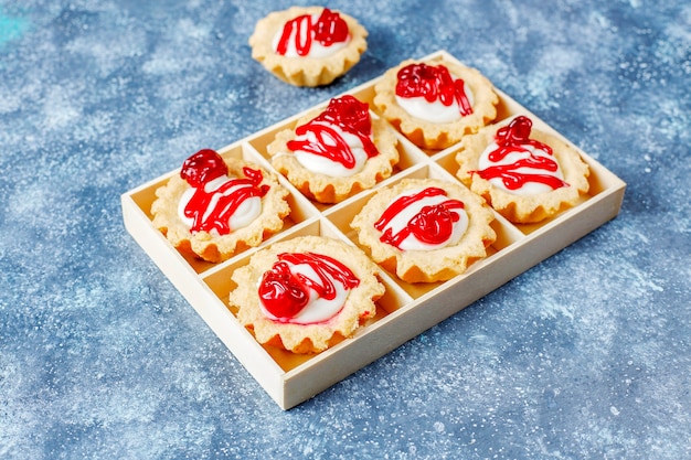 Free Photo tartlets with white chocolate filling and berry jam on top.