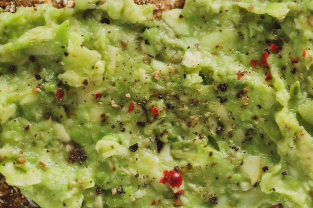 Free photo tasty appetizing crispbread with mashed avocado served on plate. closeup.