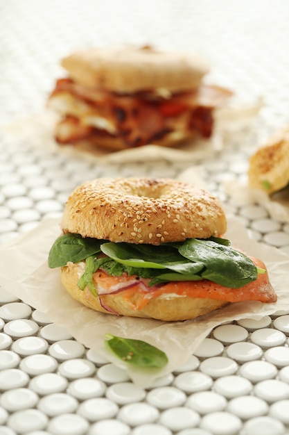 Tasty bagel sandwich with bacon