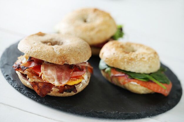 Tasty bagel sandwich with bacon