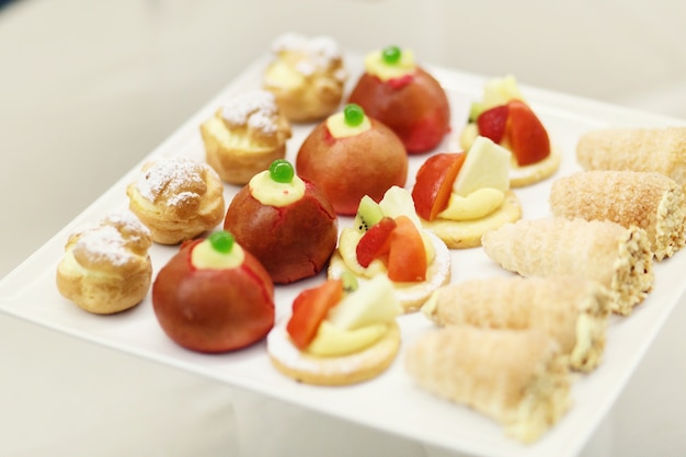 Tasty bakery with berries and fruits served on white plate 