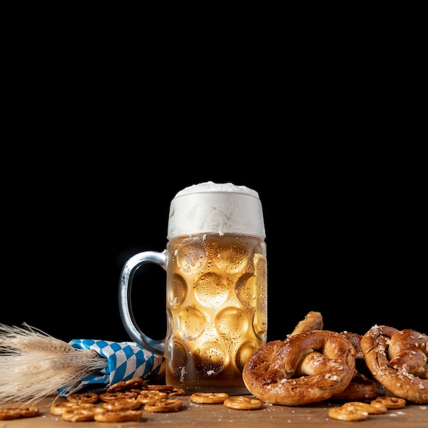 Free photo tasty bavarian beer with pretzels on a table