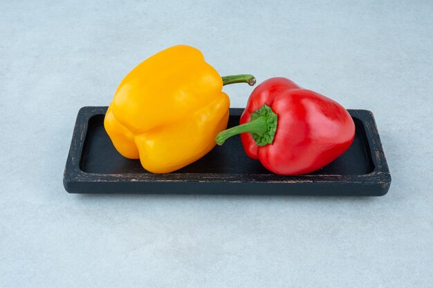 Tasty bell peppers on a board, on the marble.