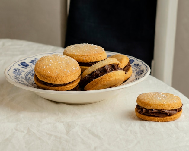 Tasty biscuits with cream on plate