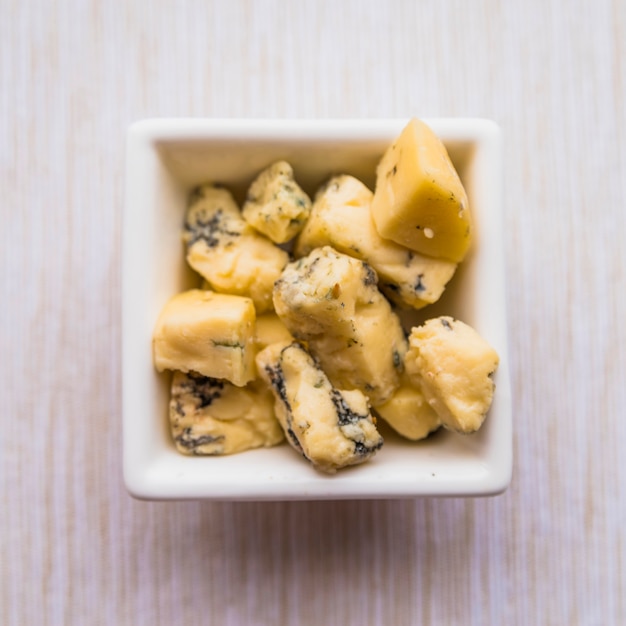 Tasty blue cheese on plate on table