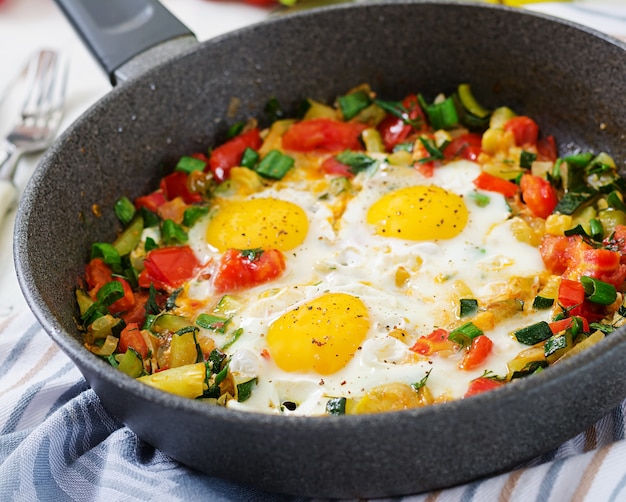 Free photo tasty breakfast. fried eggs with vegetables. shakshuka.