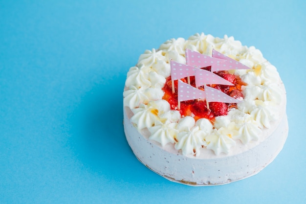 Tasty cake with flags and cream