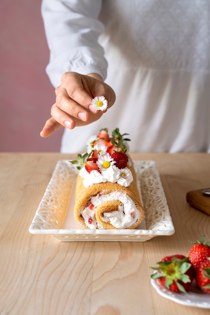 Tasty cake with strawberries on table high angle