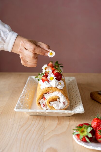 Tasty cake with strawberries on table