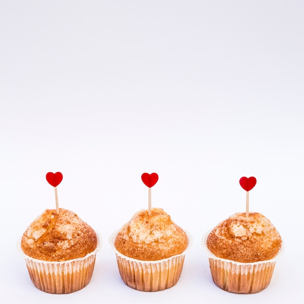 Tasty cakes with ornament hearts on wands