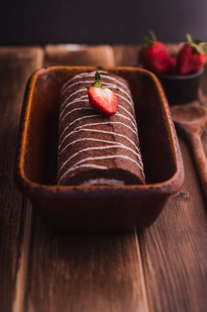 Tasty chocolate roll with strawberry on top